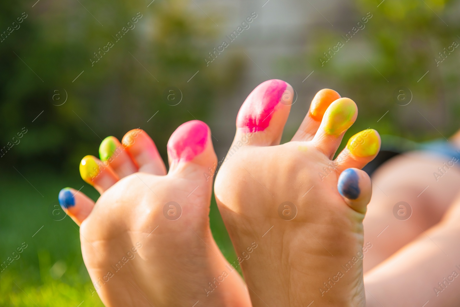 Photo of Teenage girl with painted toes outdoors, closeup