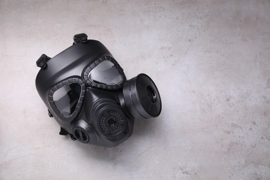 One gas mask on grey textured background, top view. Space for text