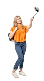 Attractive young woman taking selfie on white background