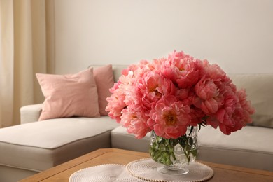 Photo of Beautiful pink peonies in vase on table at home, space for text. Interior design