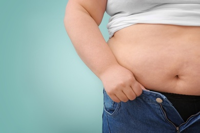 Photo of Overweight woman on color background