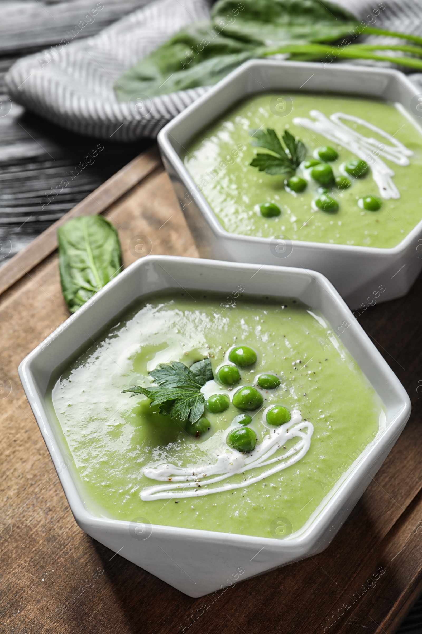 Photo of Fresh vegetable detox soup made of green peas served on table