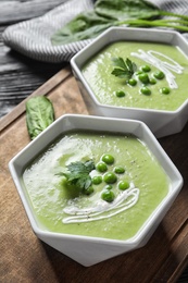 Fresh vegetable detox soup made of green peas served on table