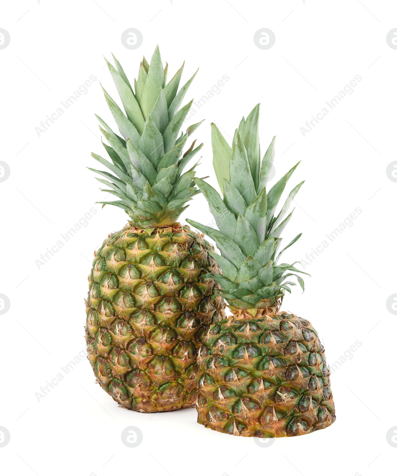Photo of Whole and cut ripe pineapples isolated on white