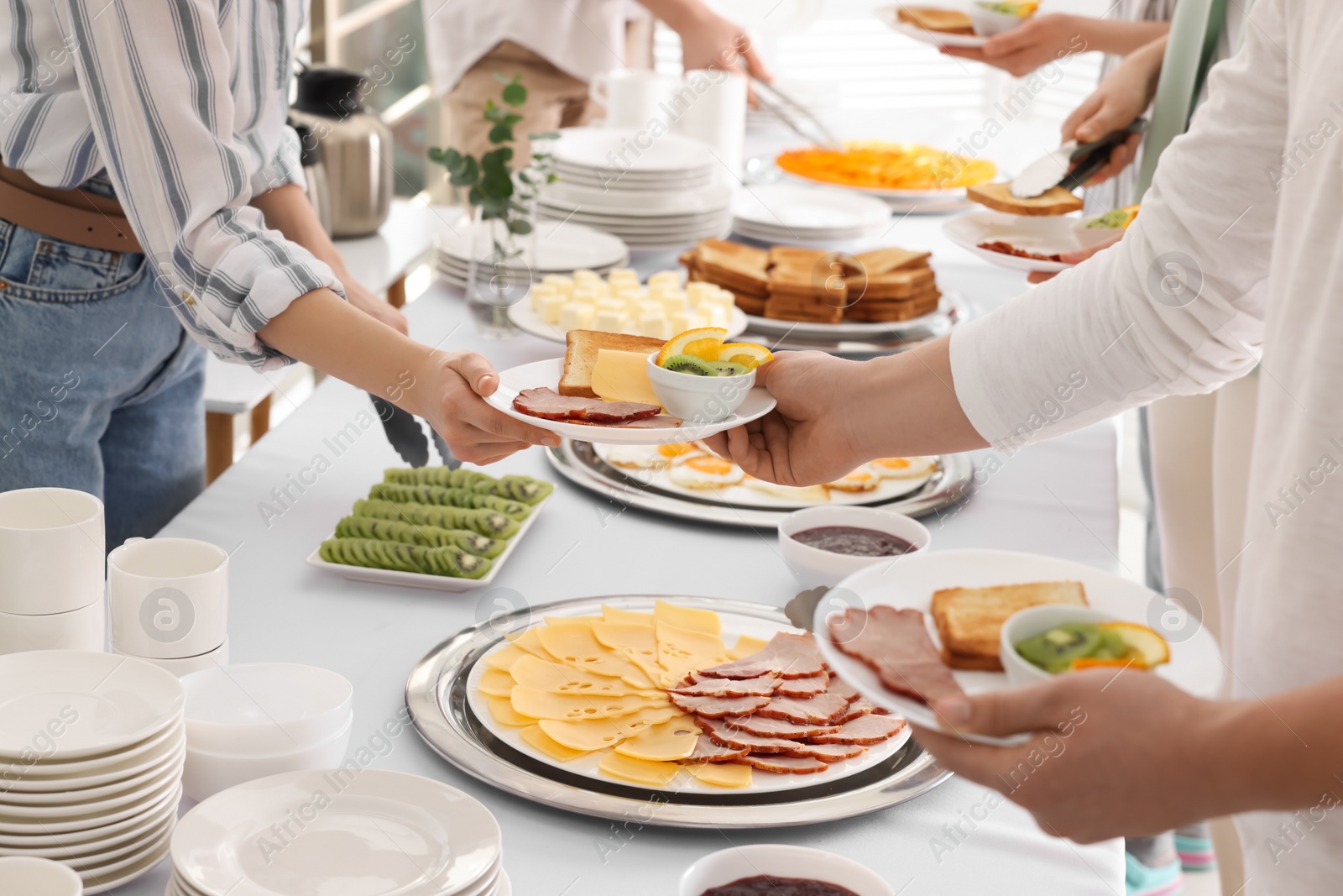 Photo of People taking food during breakfast, closeup. Buffet service