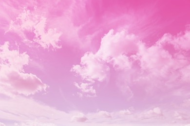 Image of Fluffy clouds floating in beautiful pink sky