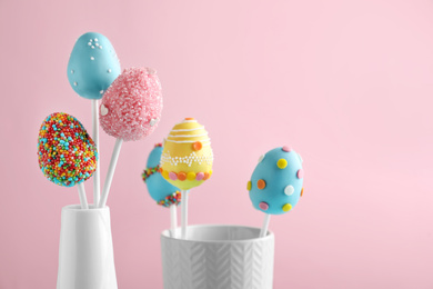 Photo of Delicious sweet cake pops on light pink background. Easter holiday
