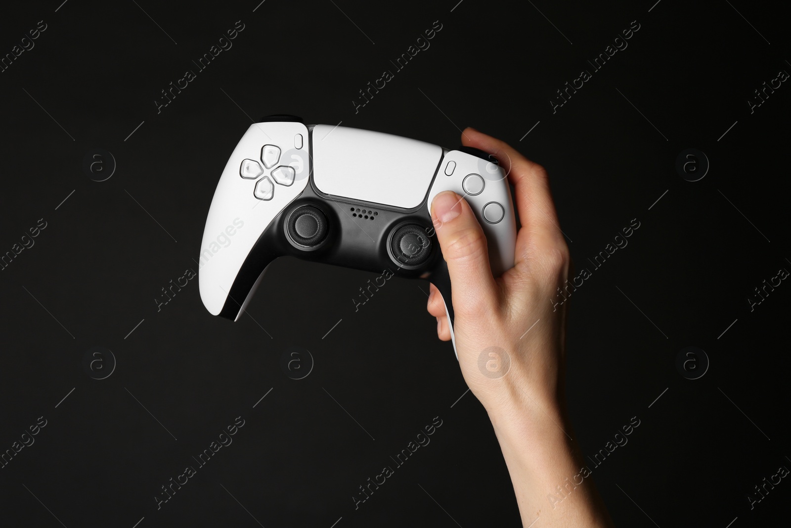 Photo of Woman with game controller on black background, closeup