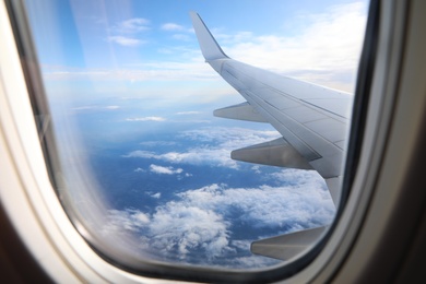 Image of Beautiful view through plane window during flight. Air travel