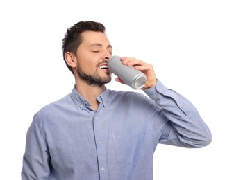 Photo of Happy man drinking from tin can on white background