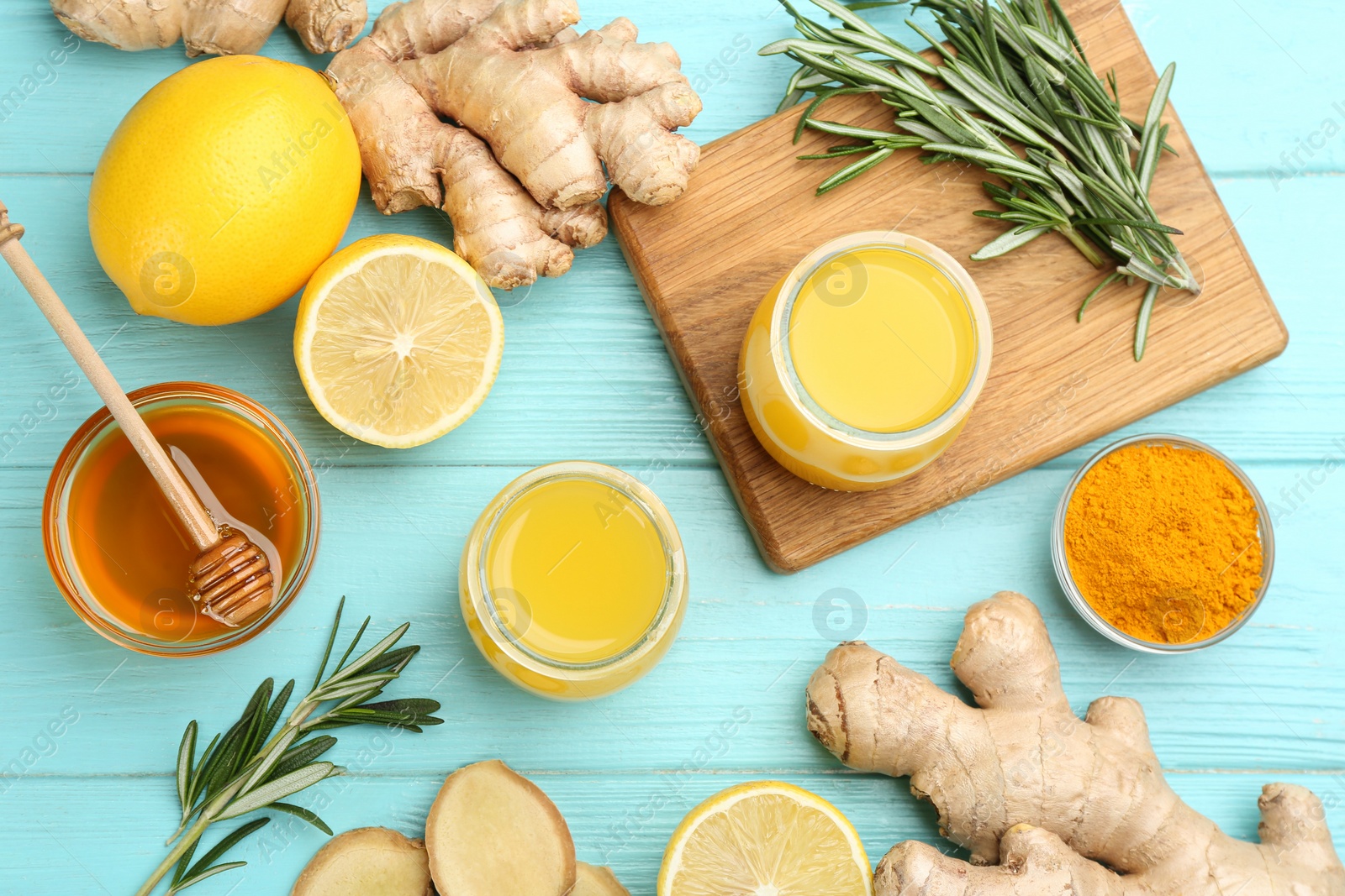 Photo of Flat lay composition with immunity boosting drink and ingredients on turquoise wooden table