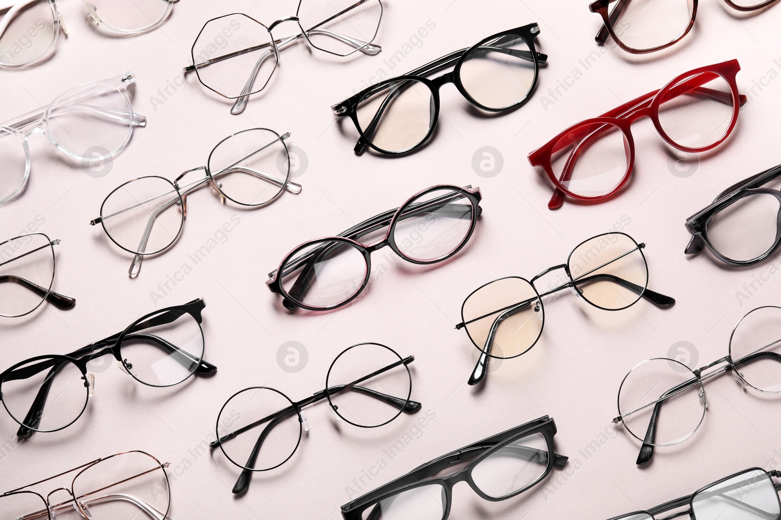 Photo of Many different stylish glasses on light grey background, flat lay