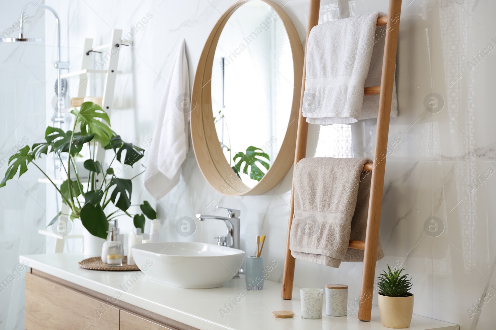 Photo of Decorative ladder near vessel sink in stylish bathroom. Idea for interior design
