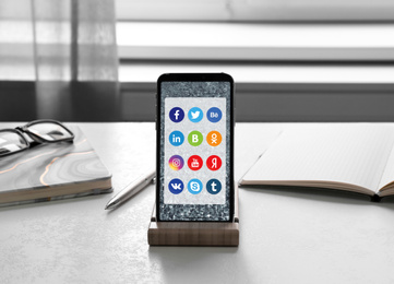 MYKOLAIV, UKRAINE - APRIL 30, 2020: Smartphone with social media apps icons on screen in office