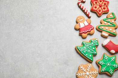 Flat lay composition with tasty homemade Christmas cookies on grey table, space for text