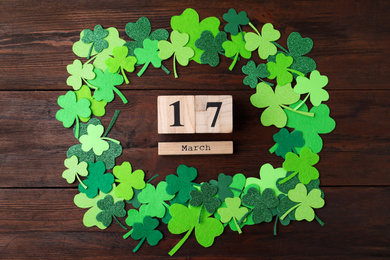 Flat lay composition with block calendar on wooden background. St. Patrick's Day celebration