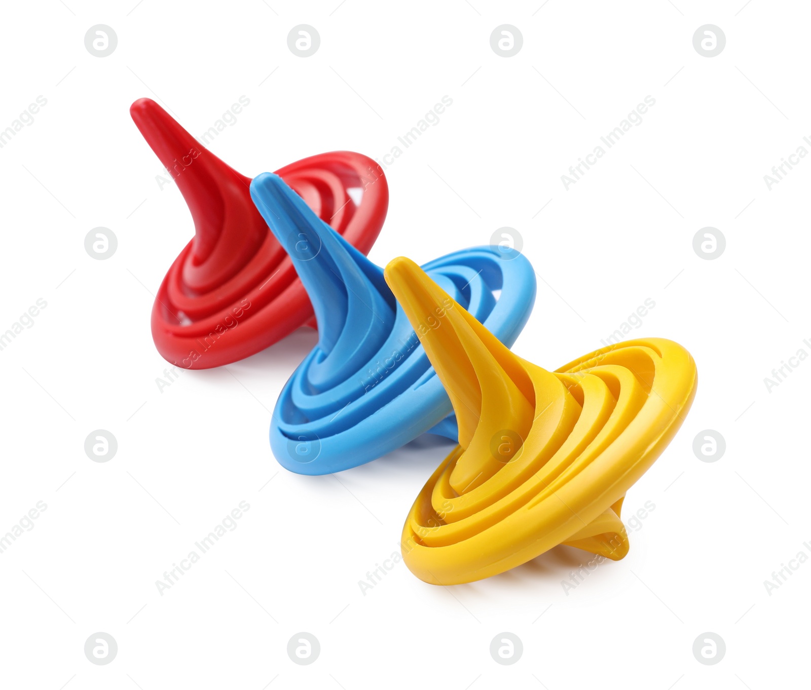 Photo of Three colorful spinning tops on white background