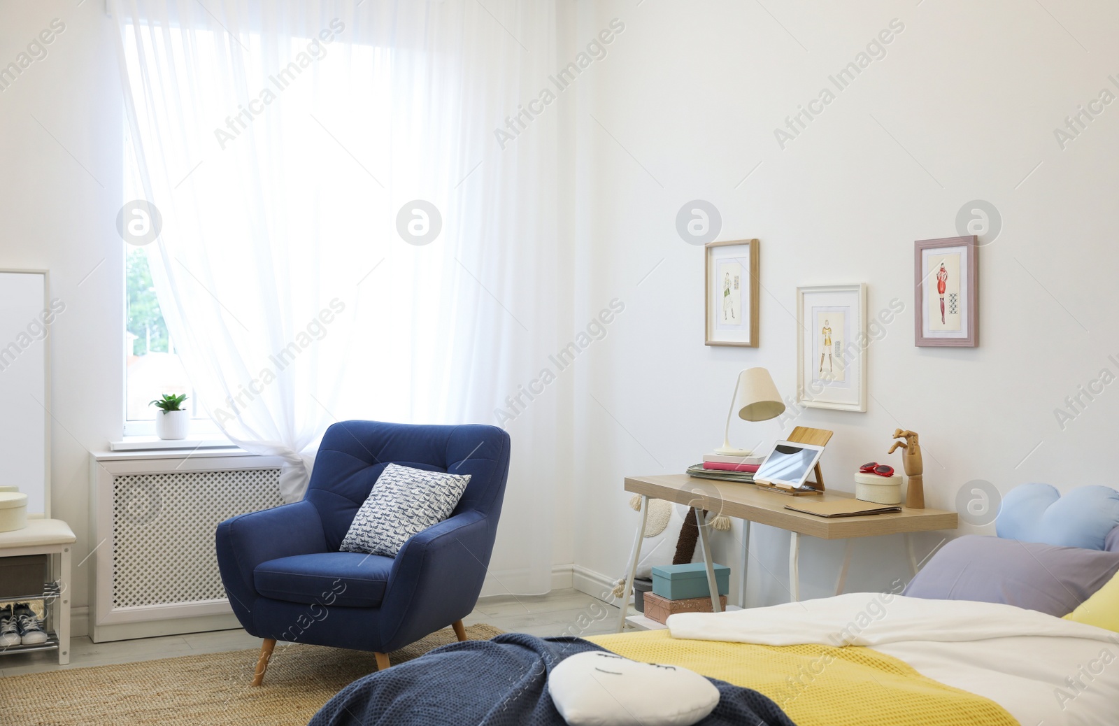 Photo of Modern teenager's room interior with bed and armchair