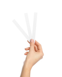 Woman holding perfume testing strips on white background, closeup