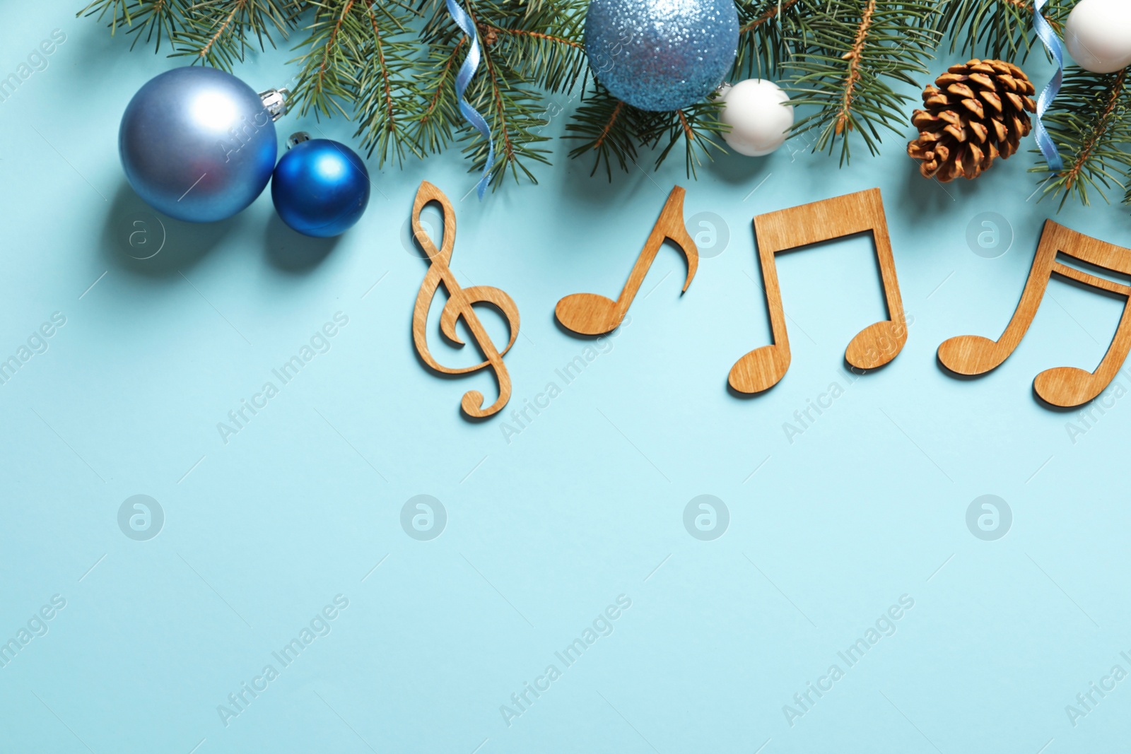 Photo of Flat lay composition with decorations and notes on color background. Christmas music concept