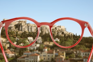 Image of Vision correction. Landscape becoming clearer when looking through glasses