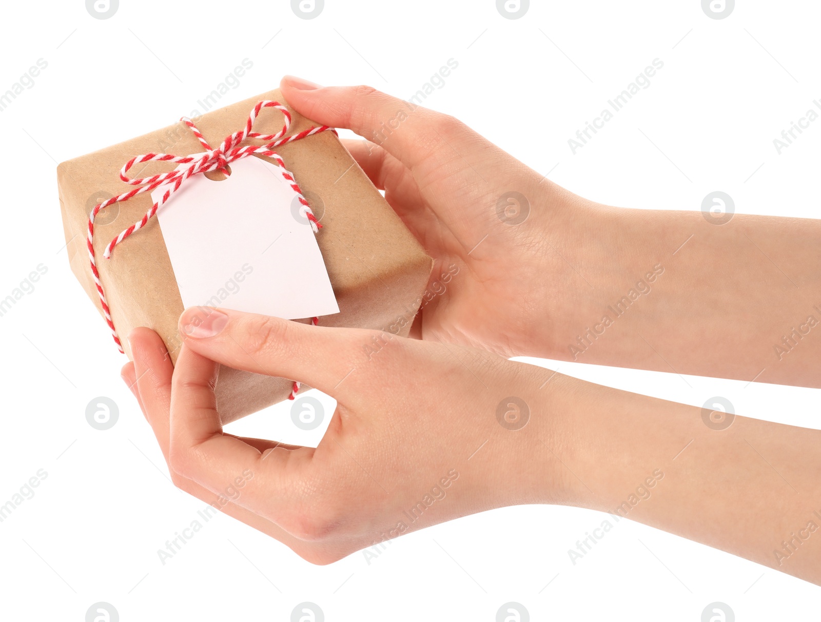 Photo of Woman holding parcel wrapped in kraft paper with tag on white background, closeup