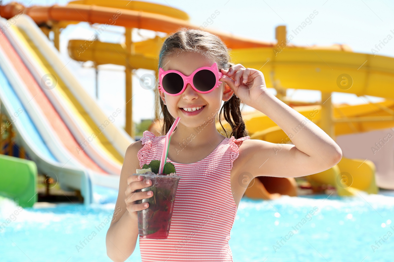 Photo of Girl with delicious refreshing drink in water park