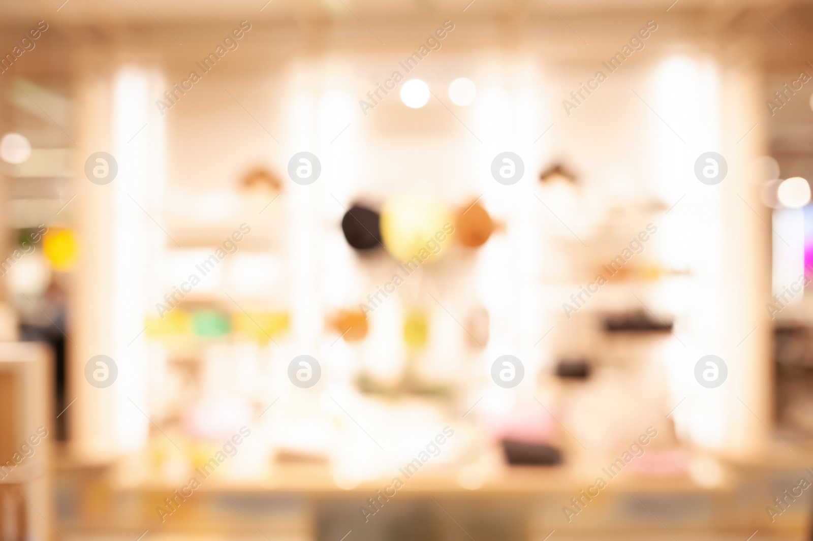 Photo of Blurred view of modern boutique interior with stylish clothes