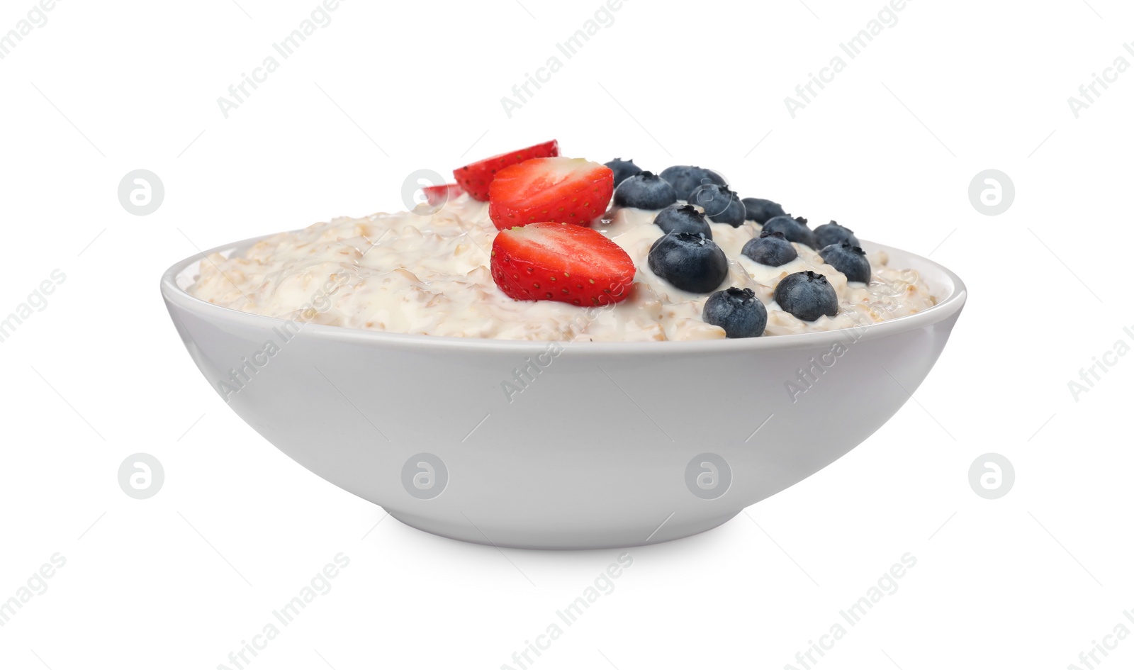 Photo of Tasty boiled oatmeal with berries in bowl isolated on white