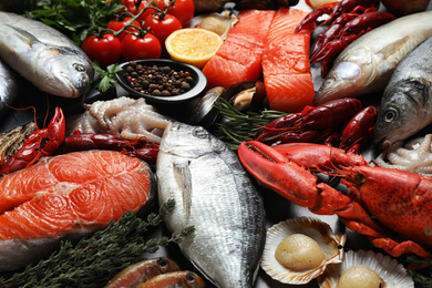 Photo of Fresh fish and different seafood on table, closeup