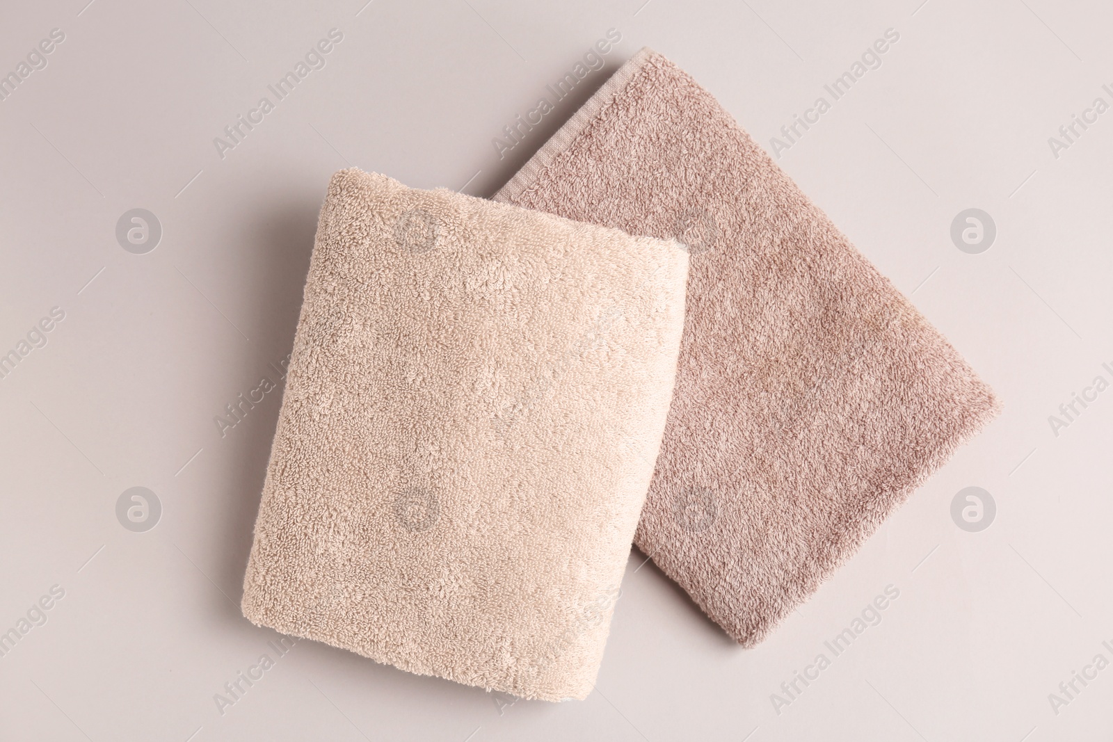 Photo of Soft bath towels on grey background, top view