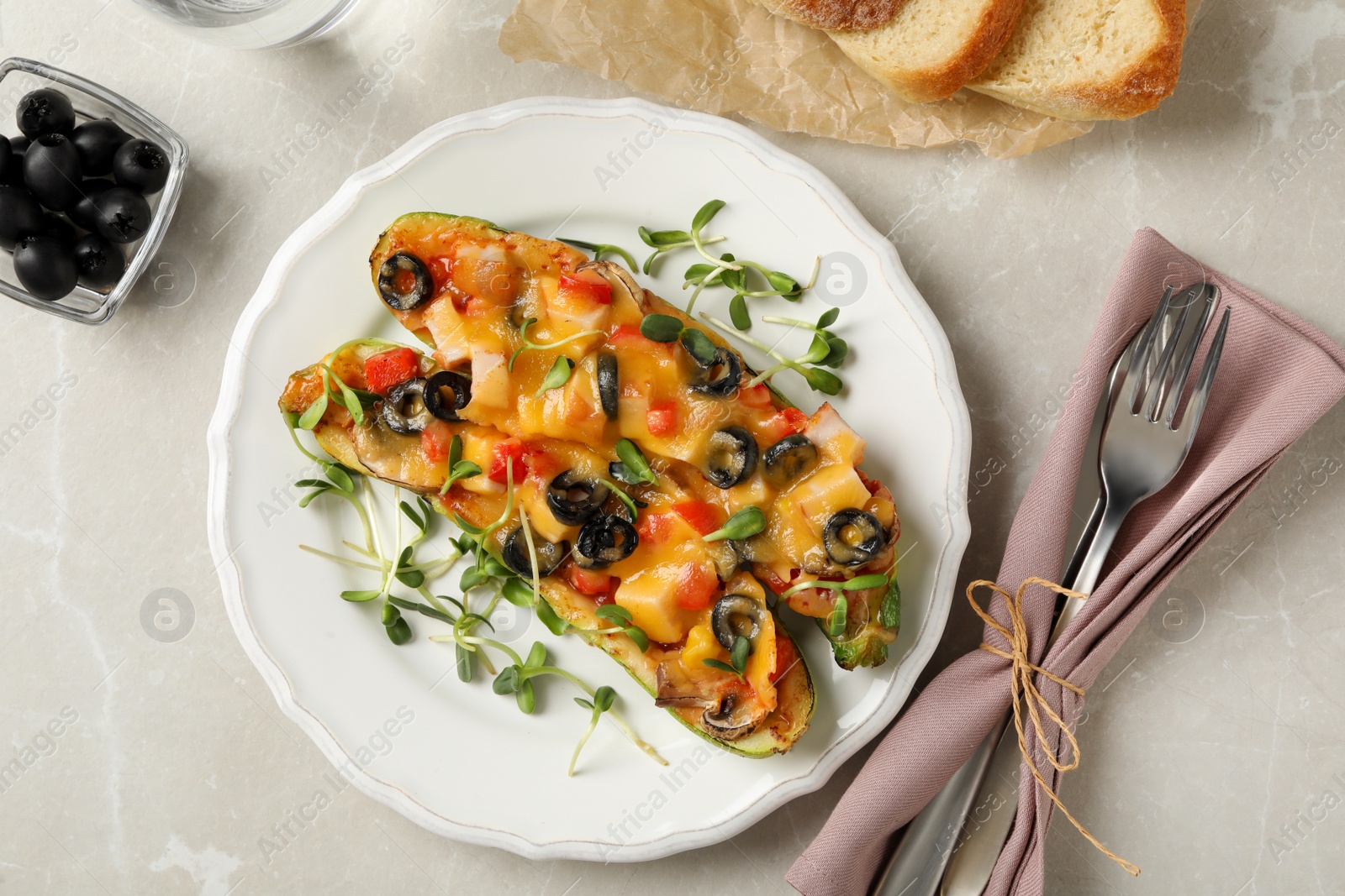 Photo of Flat lay composition baked stuffed zucchinis served on light grey table