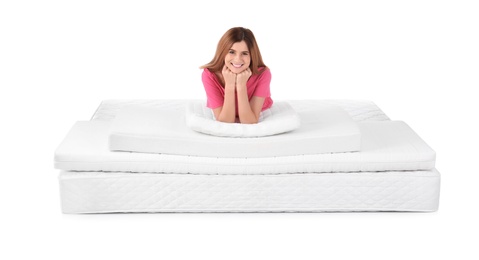 Photo of Woman lying on mattress pile against white background