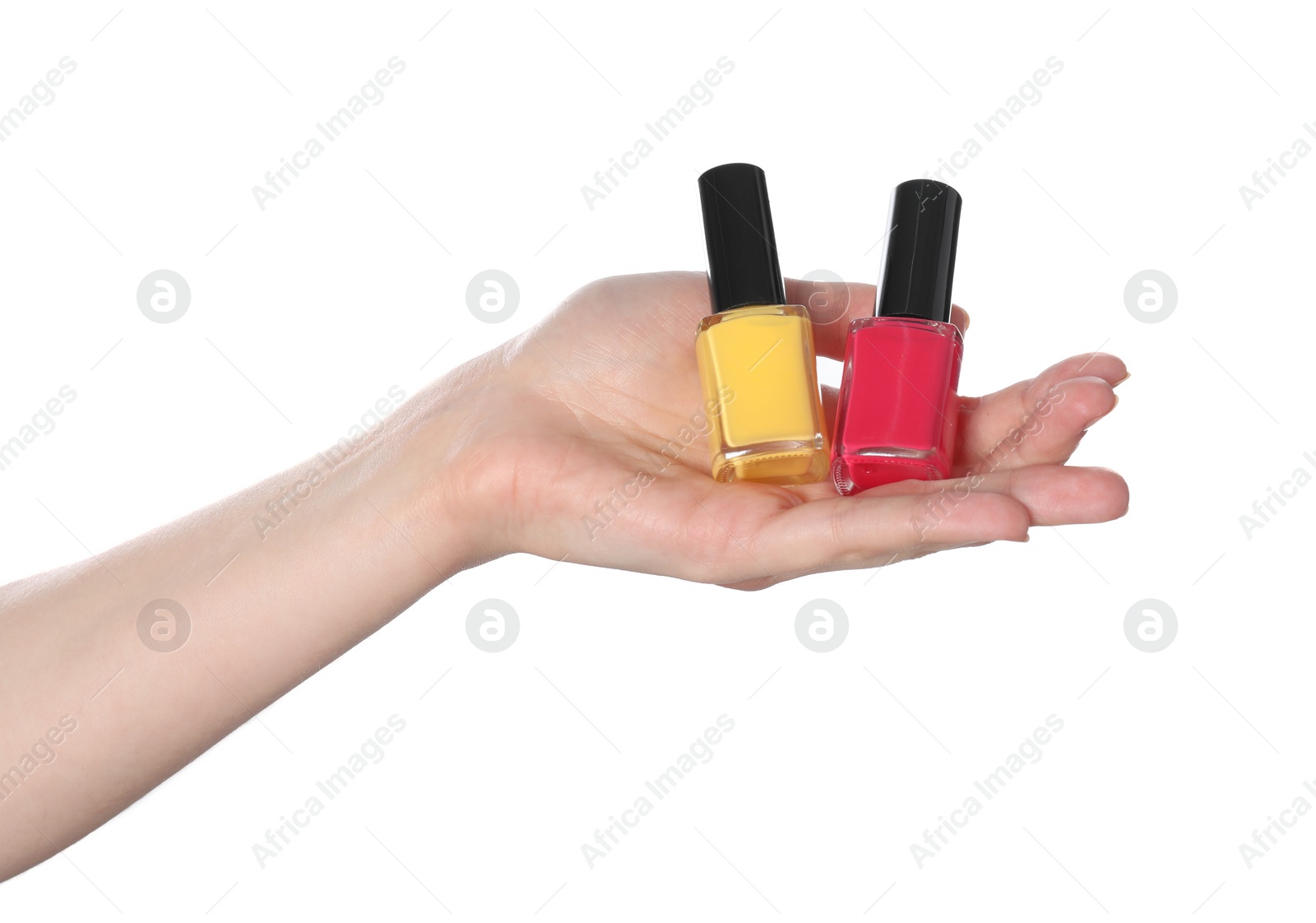 Photo of Woman holding nail polishes on white background, closeup