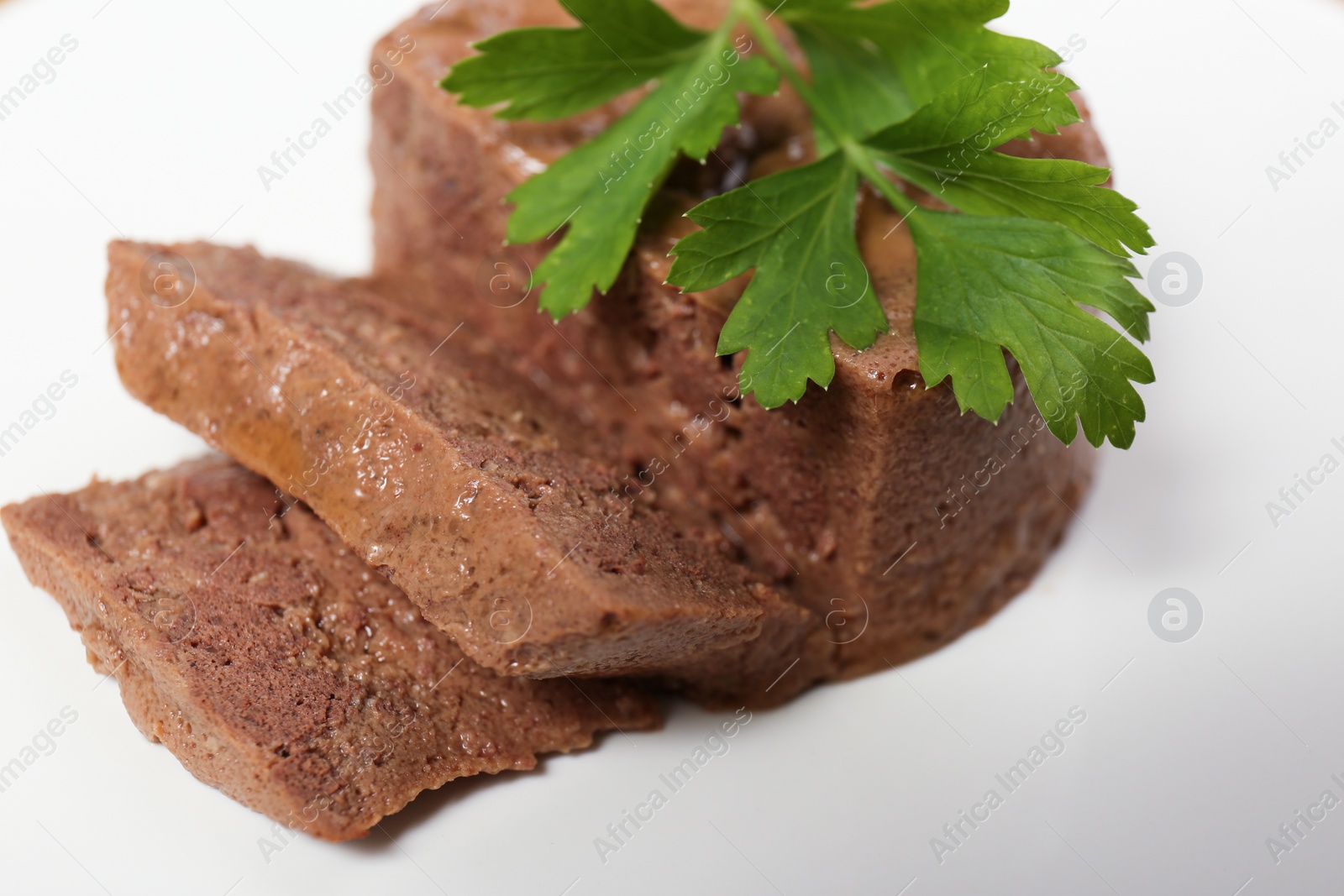 Photo of Pate with parsley on white plate, closeup. Pet food