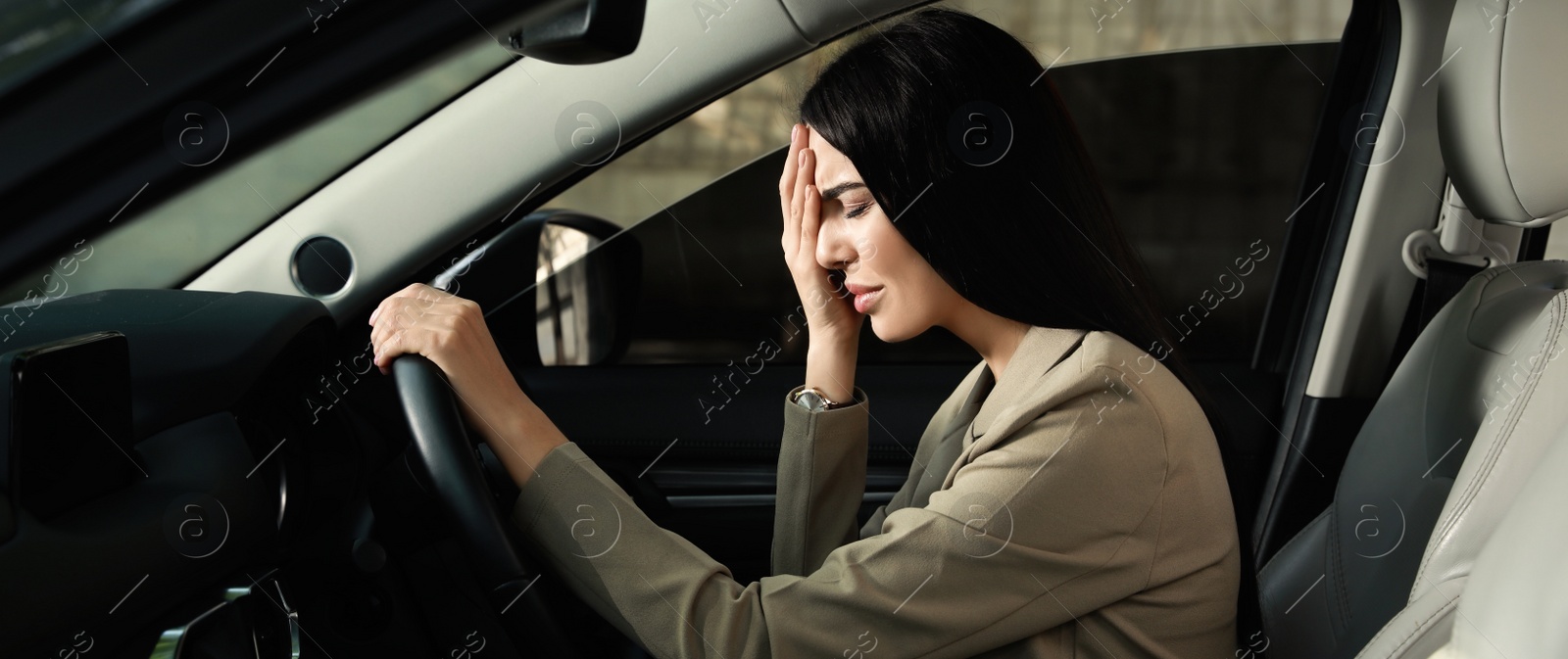 Image of Tired young woman driver's seat of modern car. Banner design