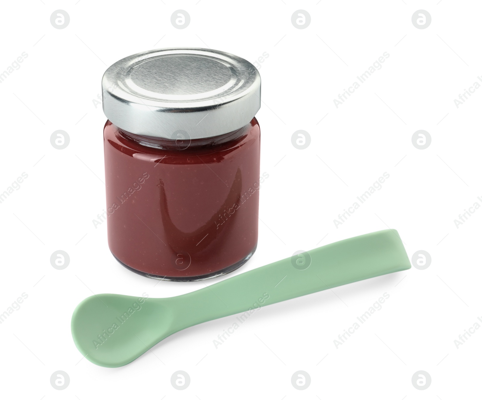 Photo of Jar of healthy baby food and spoon on white background