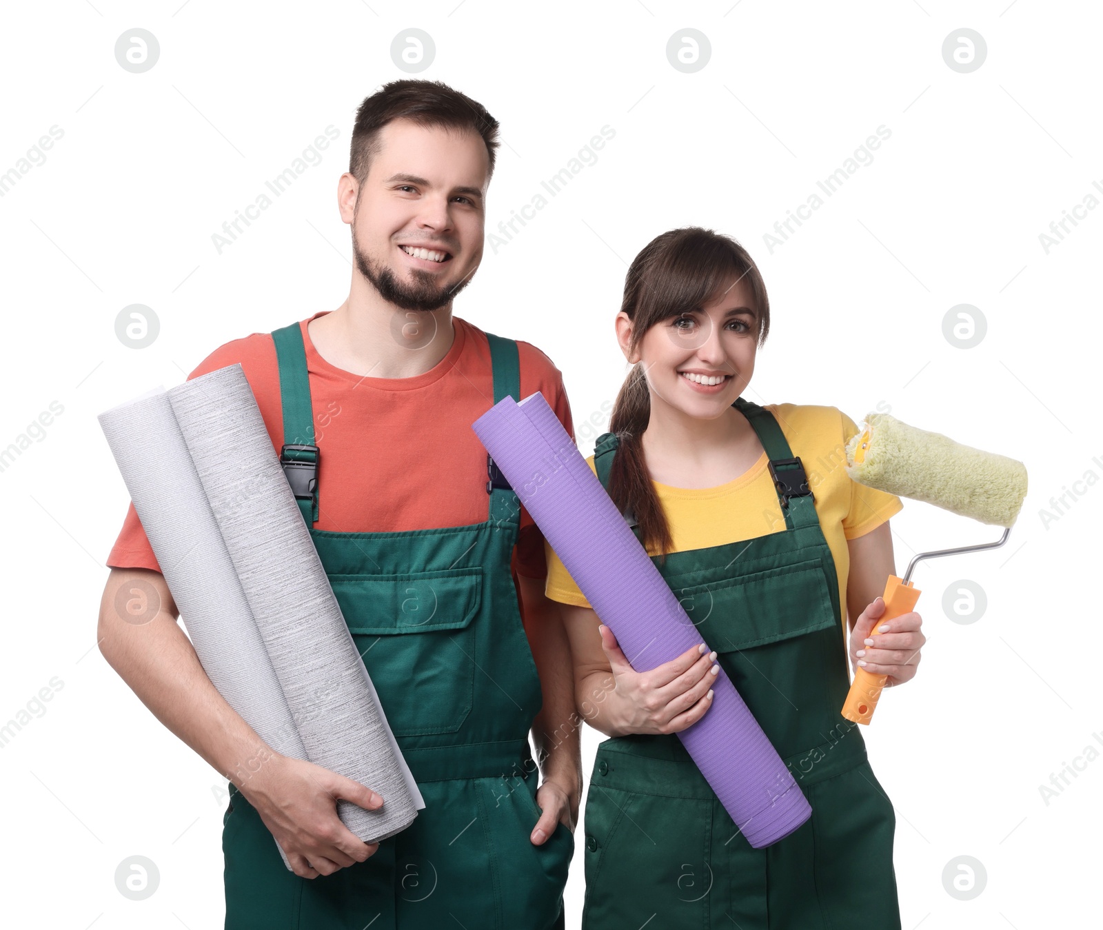 Photo of Workers with wallpaper rolls and roller on white background