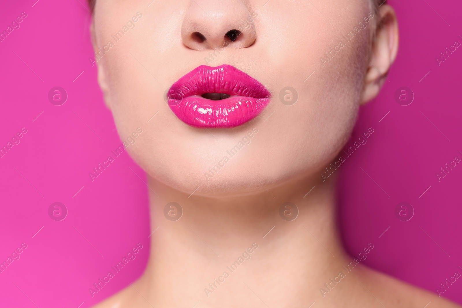 Photo of Beautiful young woman with perfect lips makeup on color background, closeup