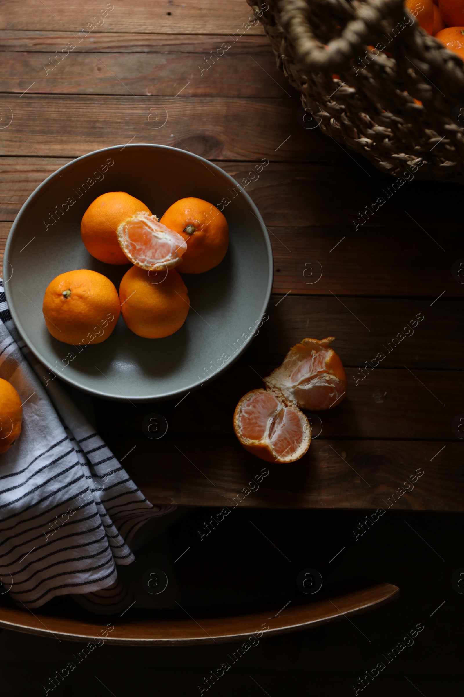 Photo of Fresh ripe tangerines on wooden table, flat lay