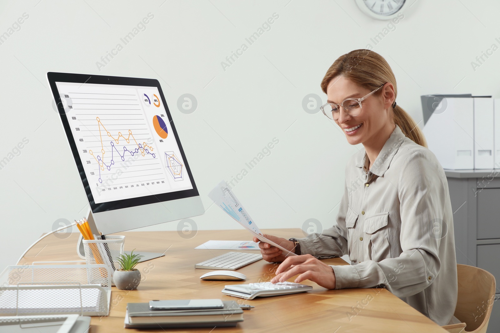 Photo of Professional accountant working at wooden desk in office