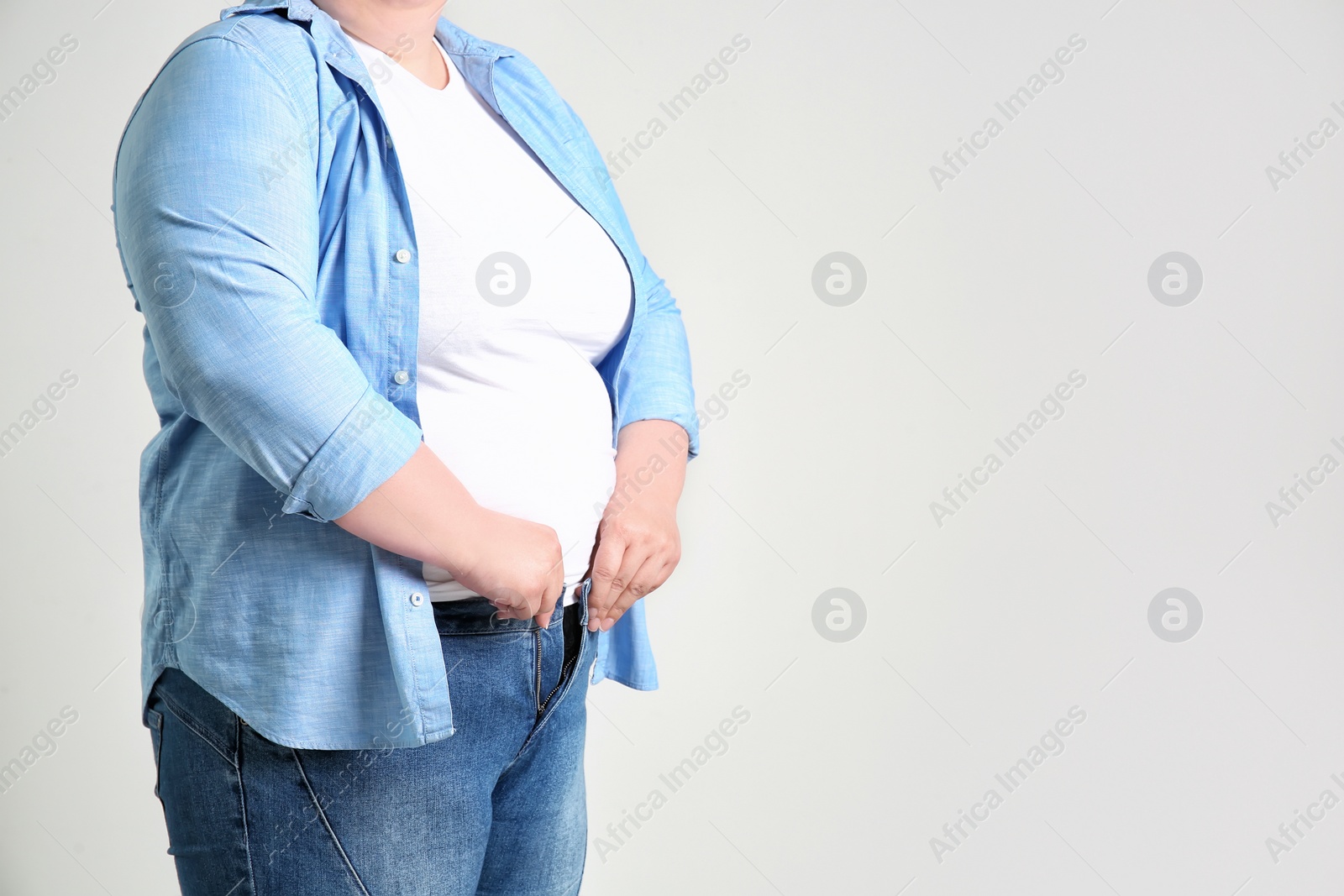 Photo of Overweight woman on light background