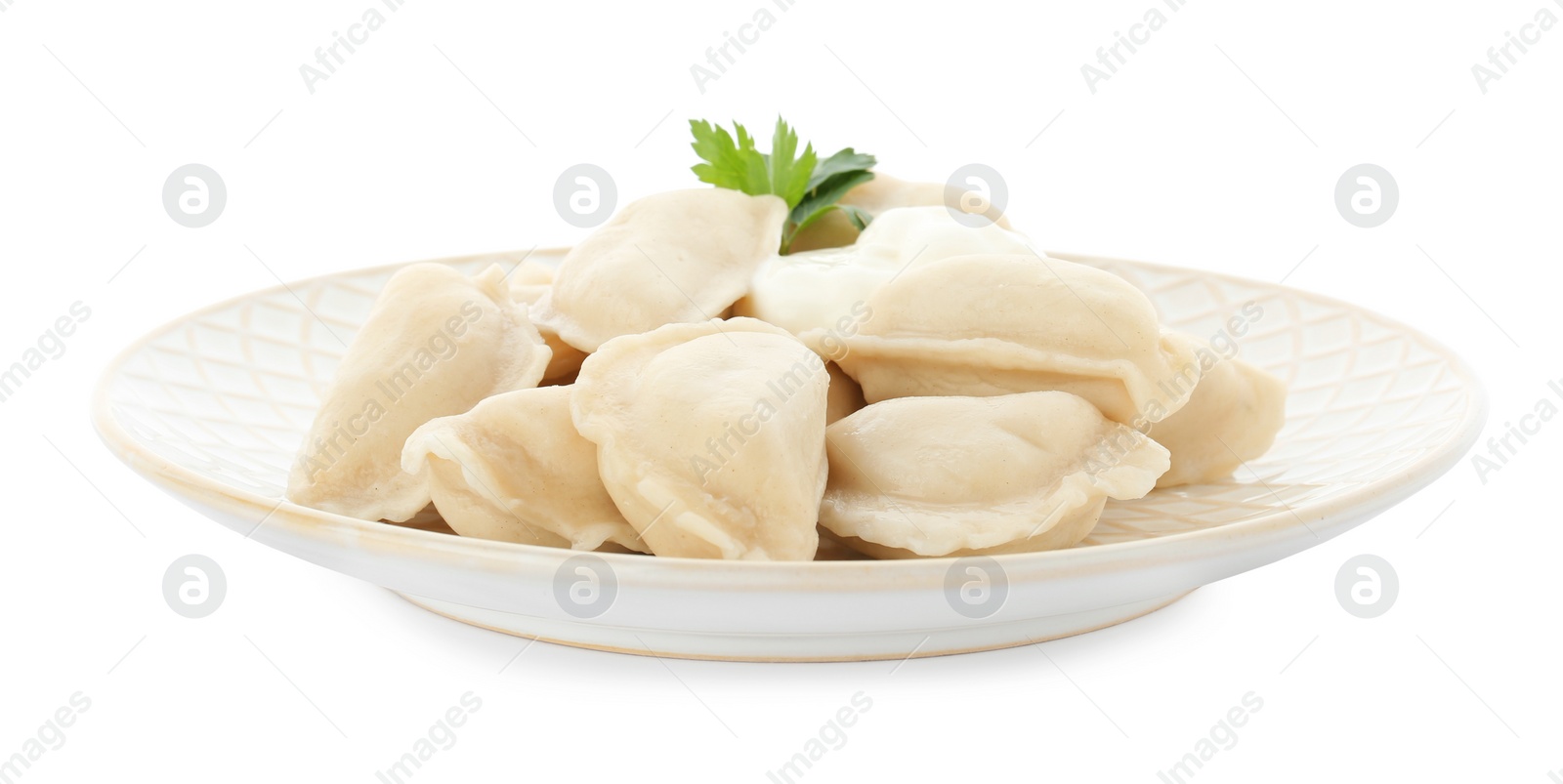 Photo of Plate of tasty dumplings with sour cream and parsley isolated on white