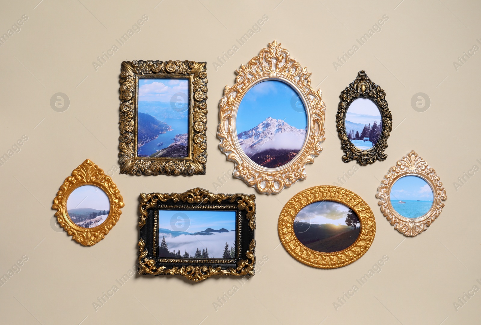 Photo of Vintage frames with photos of beautiful landscapes hanging on beige wall