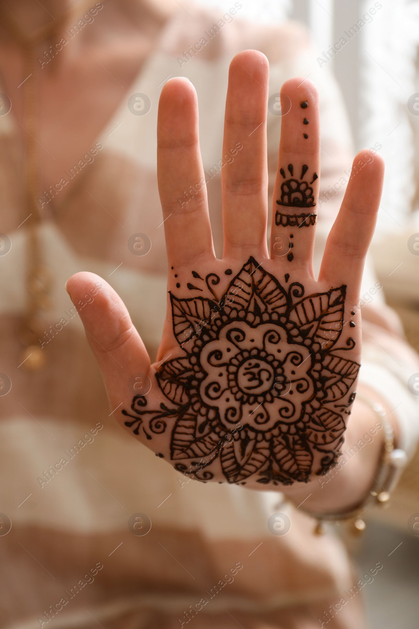 Photo of Woman with henna tattoo on palm, closeup. Traditional mehndi ornament