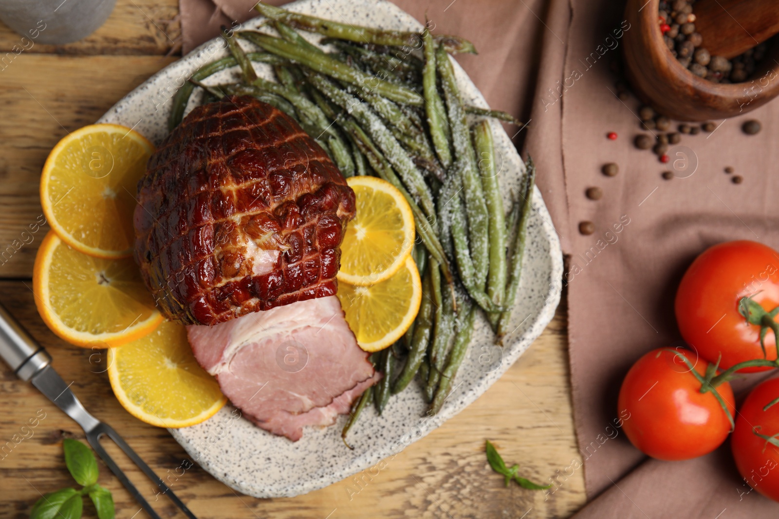 Photo of Delicious ham served with green beans and orange on wooden table, flat lay