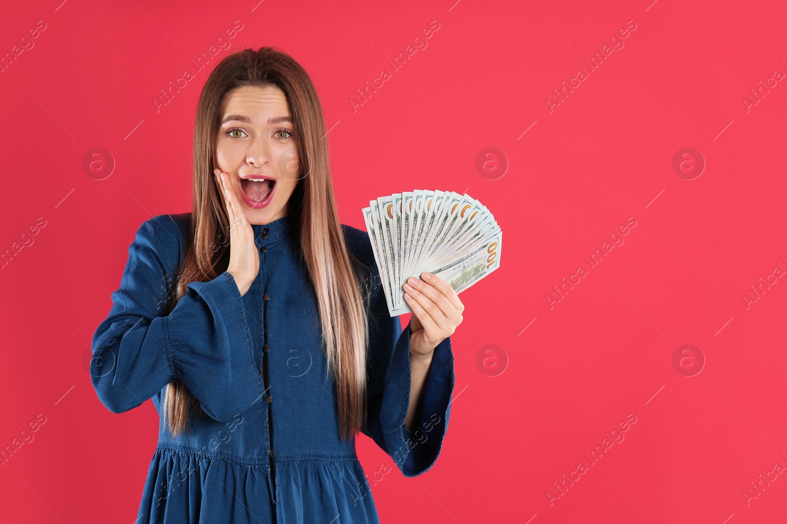 Photo of Young woman with money on crimson background. Space for text