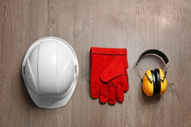 Photo of Flat lay composition with safety equipment on wooden background