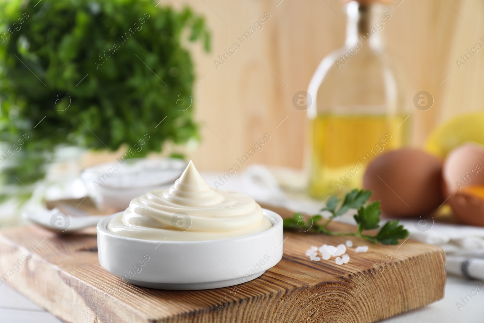 Photo of Fresh mayonnaise sauce in bowl on table