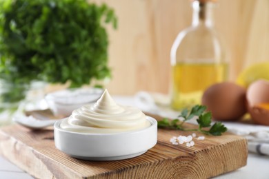 Photo of Fresh mayonnaise sauce in bowl on table